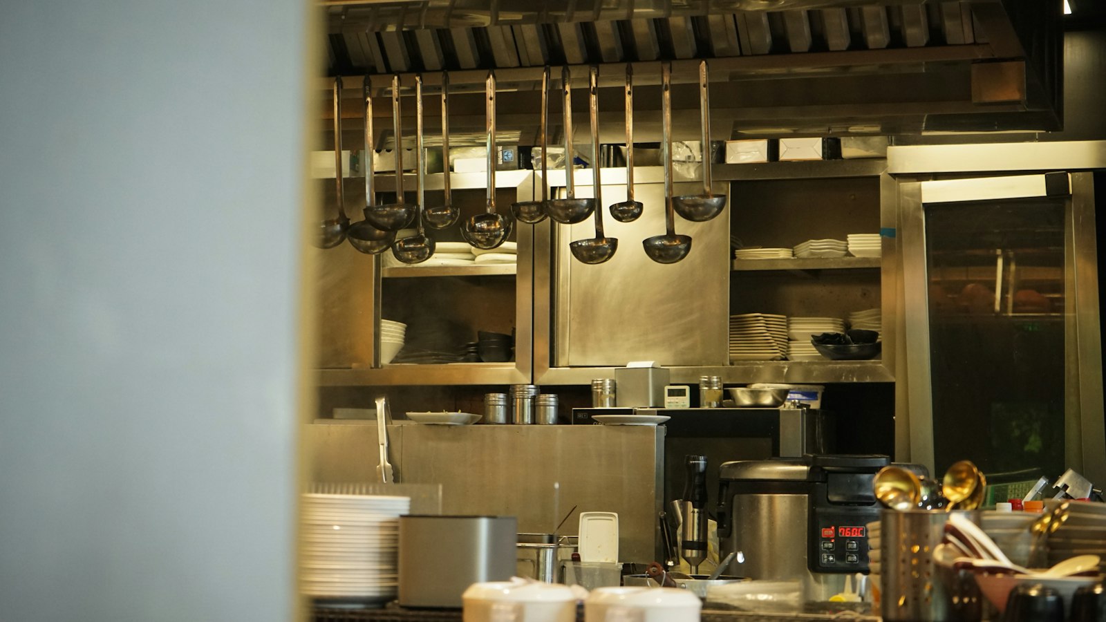 Ustensiles suspendus dans une cuisine professionnelle : le lexique de l'hôtellerie-restauration dans les hôtels, cafés, restaurants