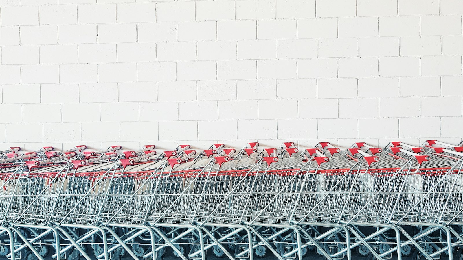 Chariots de supermarché alignés contre un mur blanc : le régime applicable au gérant de succursale