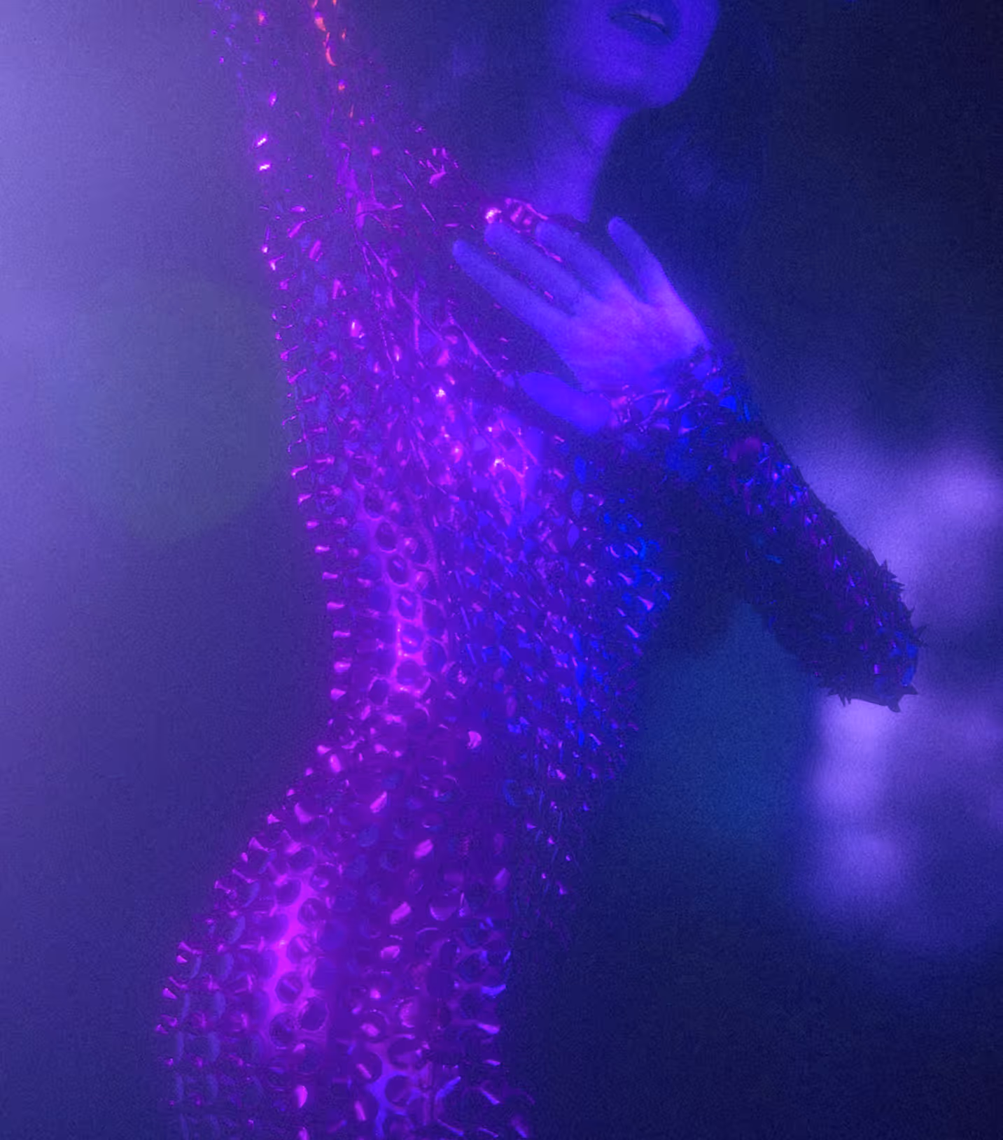 A woman dancing in a moody purple-pink-blue space, from Death to Stock by Allie Lehman.