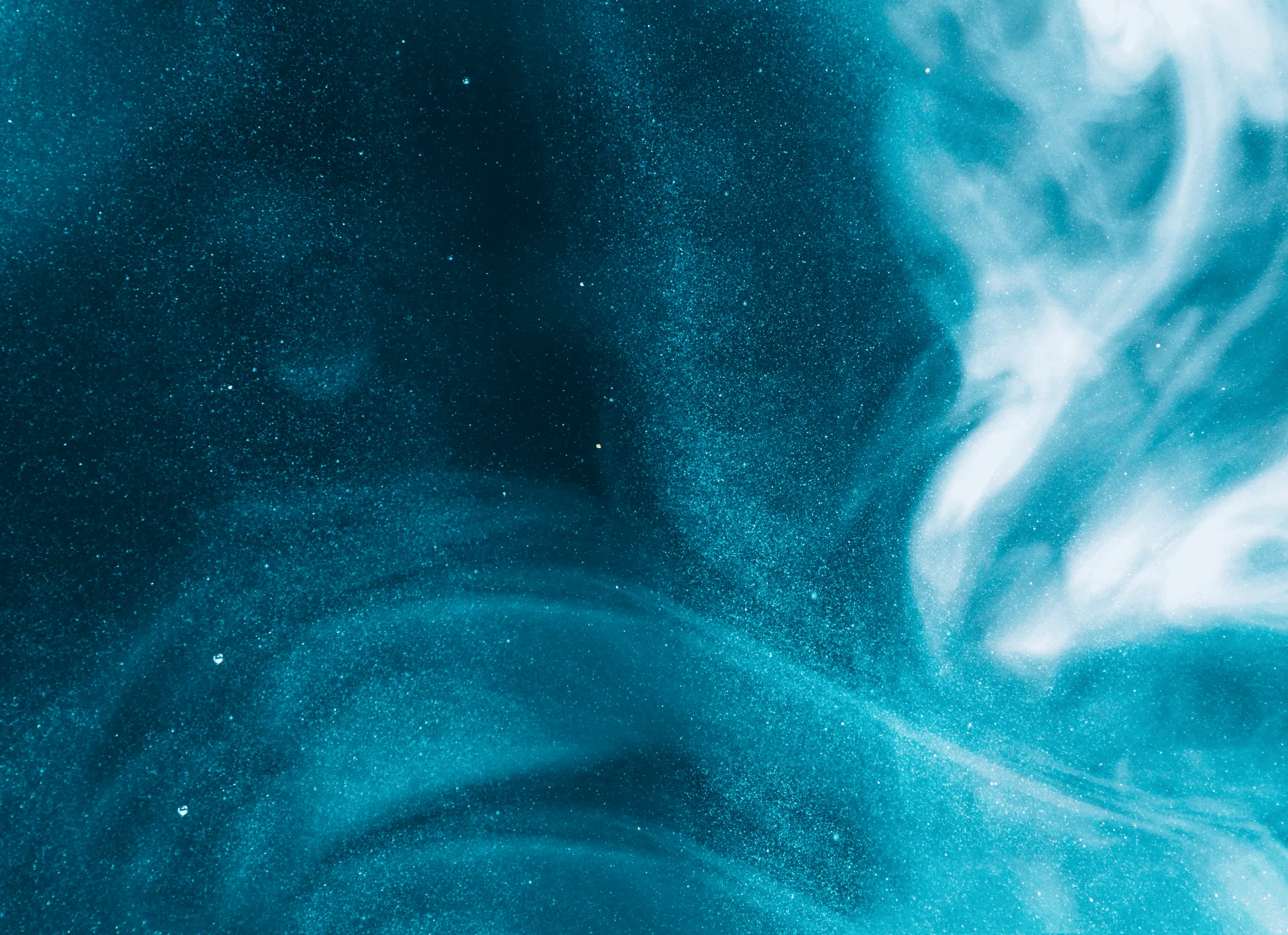 Abstract blue and white swirling mist or smoke pattern with sparkling particles on a dark background.