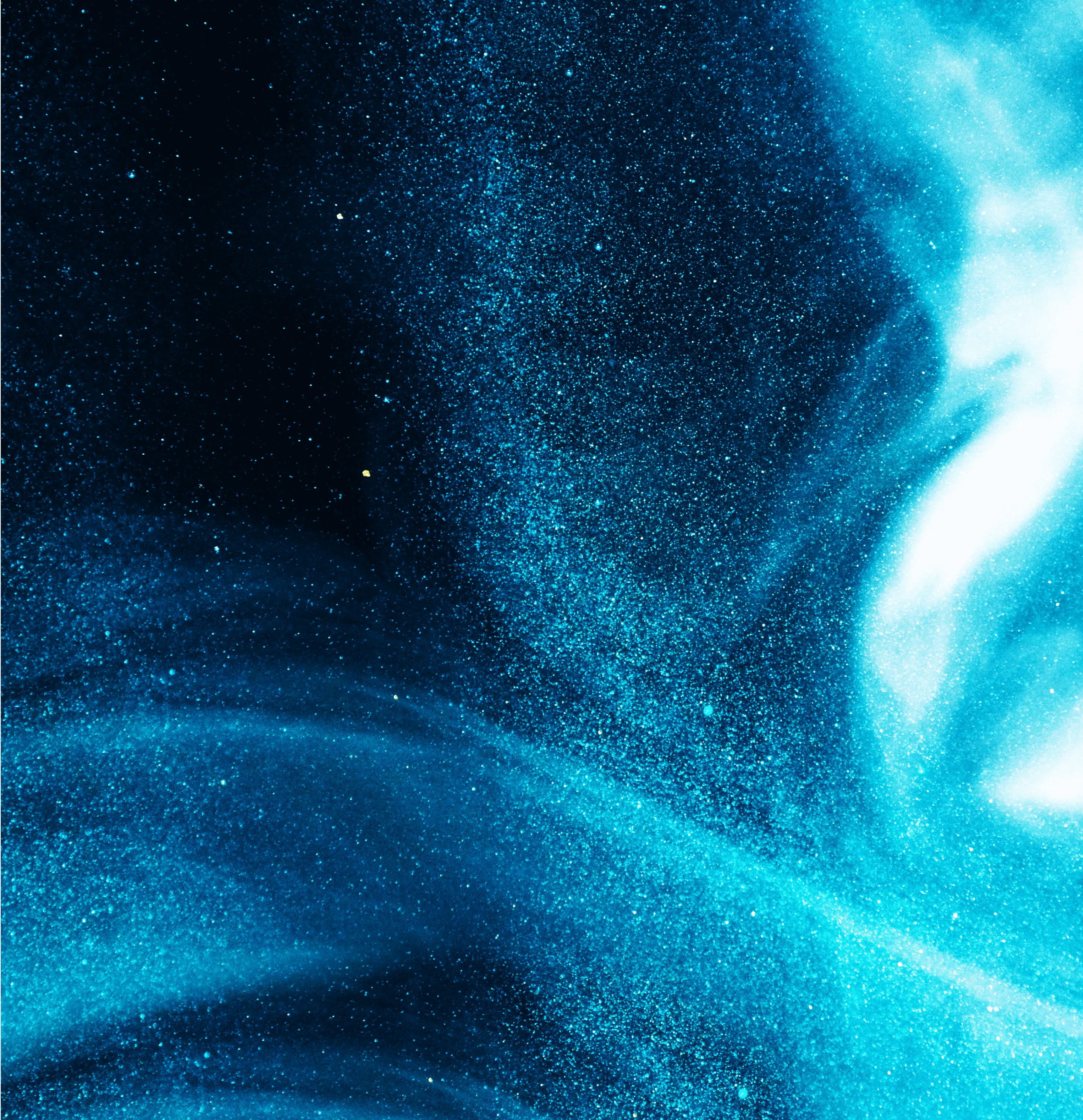 Blue and black swirling abstract pattern with scattered specks resembling cosmic dust or particles.