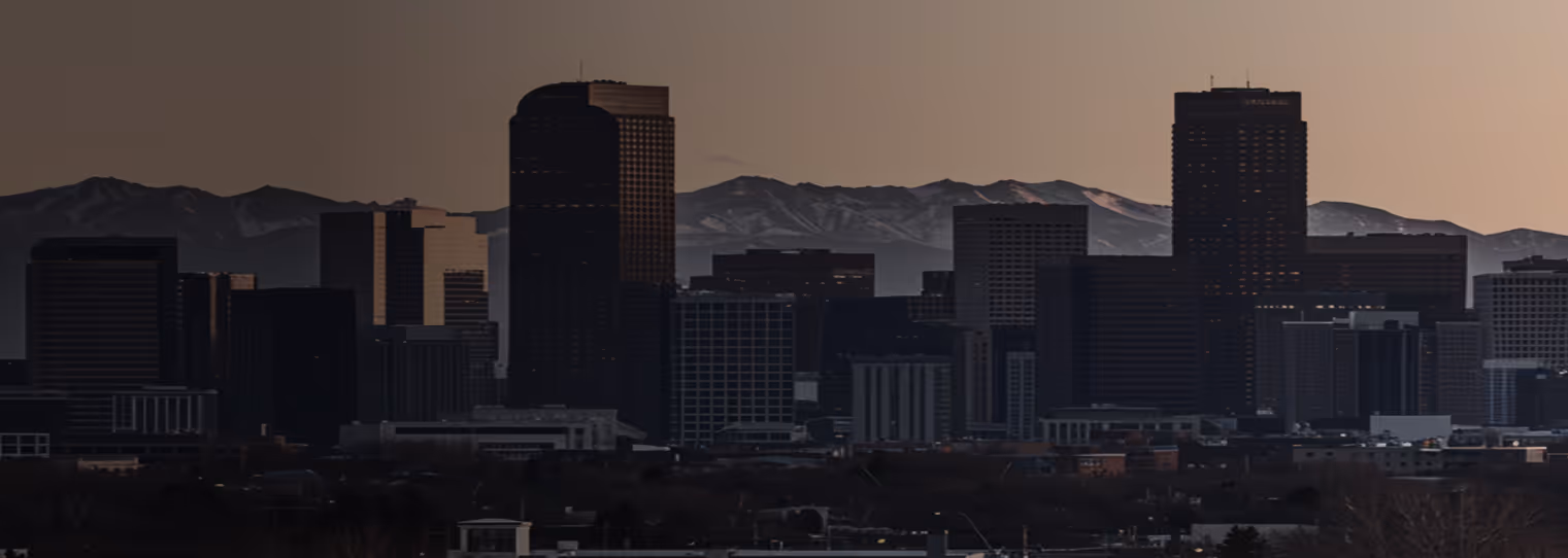 Downtown Denver, Colorado skyline with the Rocky Mountains at sunset