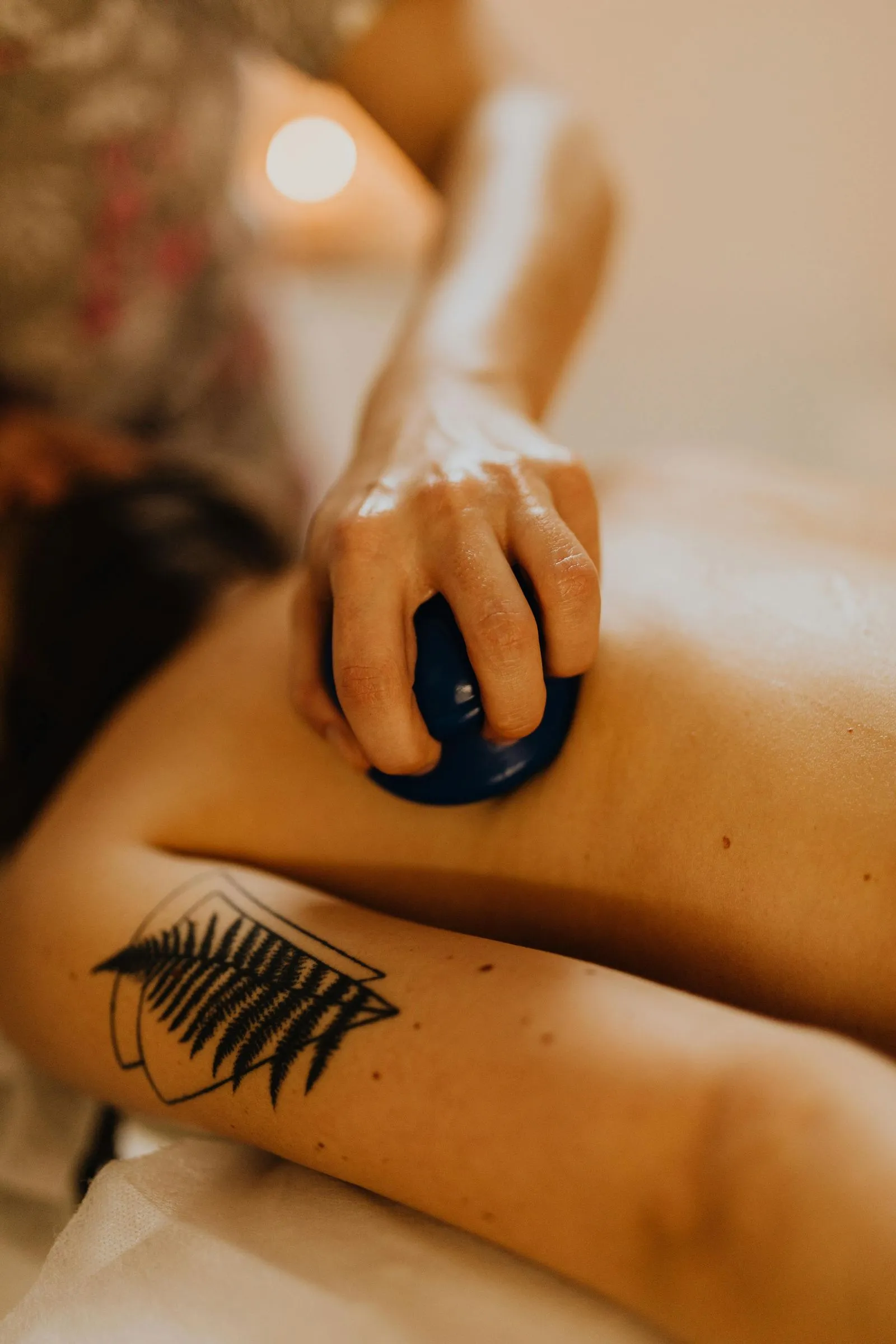 Therapist using cupping tool on back