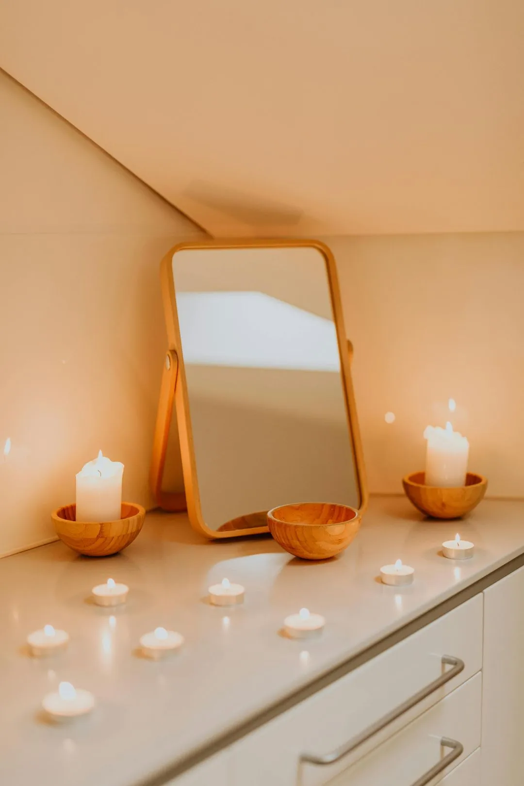 Mirror with lit candles on a counter