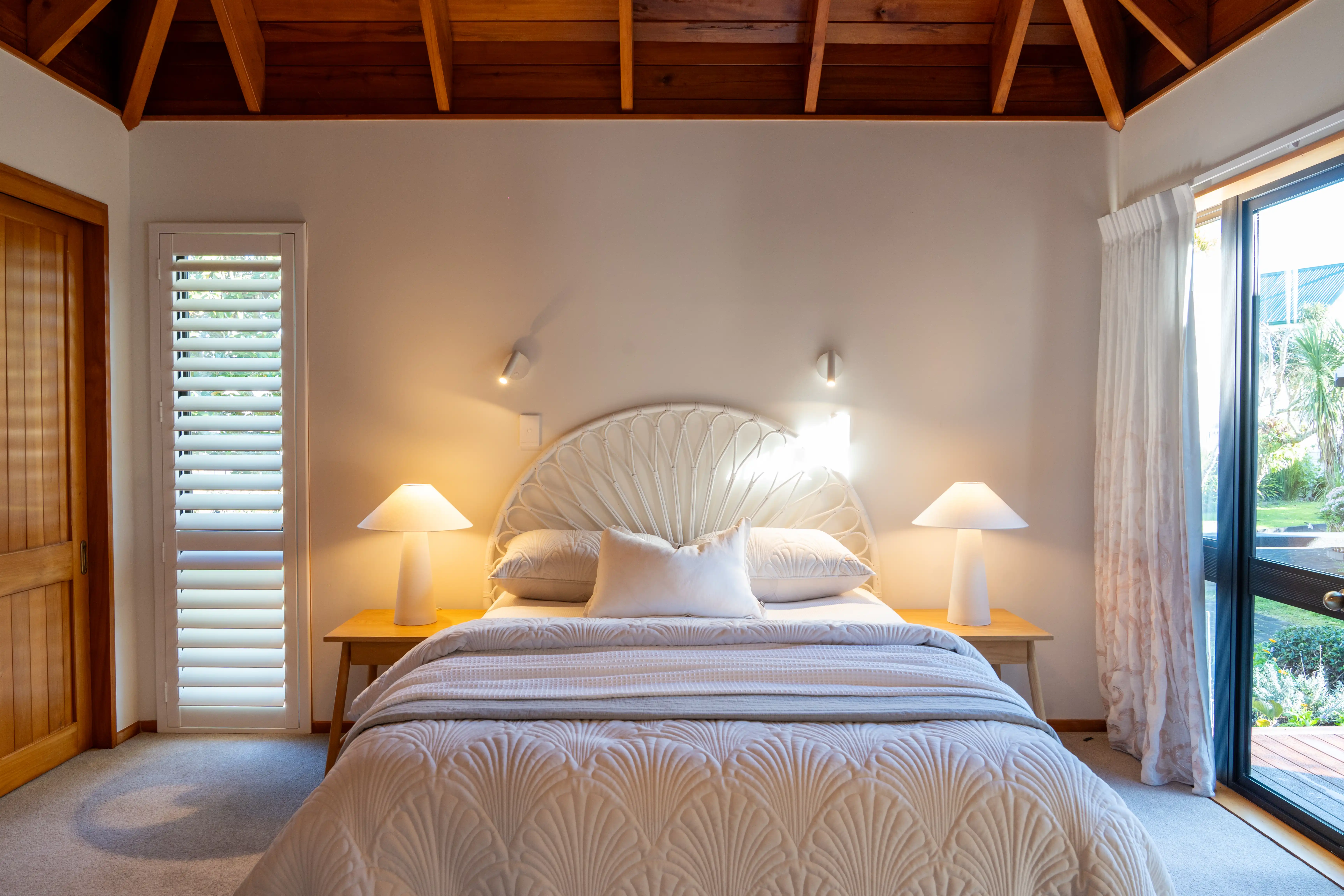 A double bedroom in a villa, looking out to the garden.