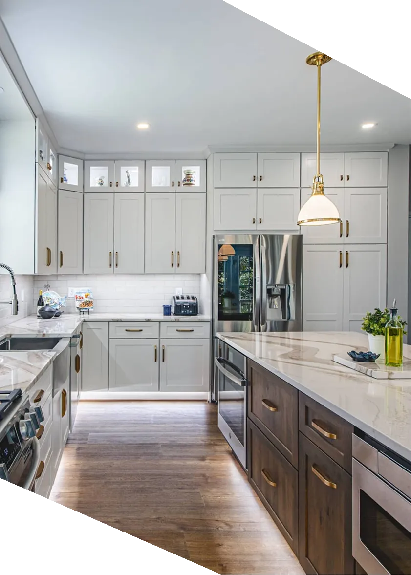 Modern kitchen with gray cabinets, marble countertops, wooden island, stainless steel appliances, and pendant light.