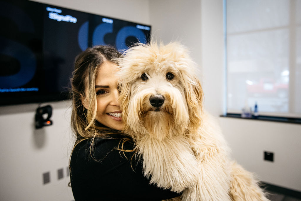 Heather Doshay sits with a very cute, curly-haired dog