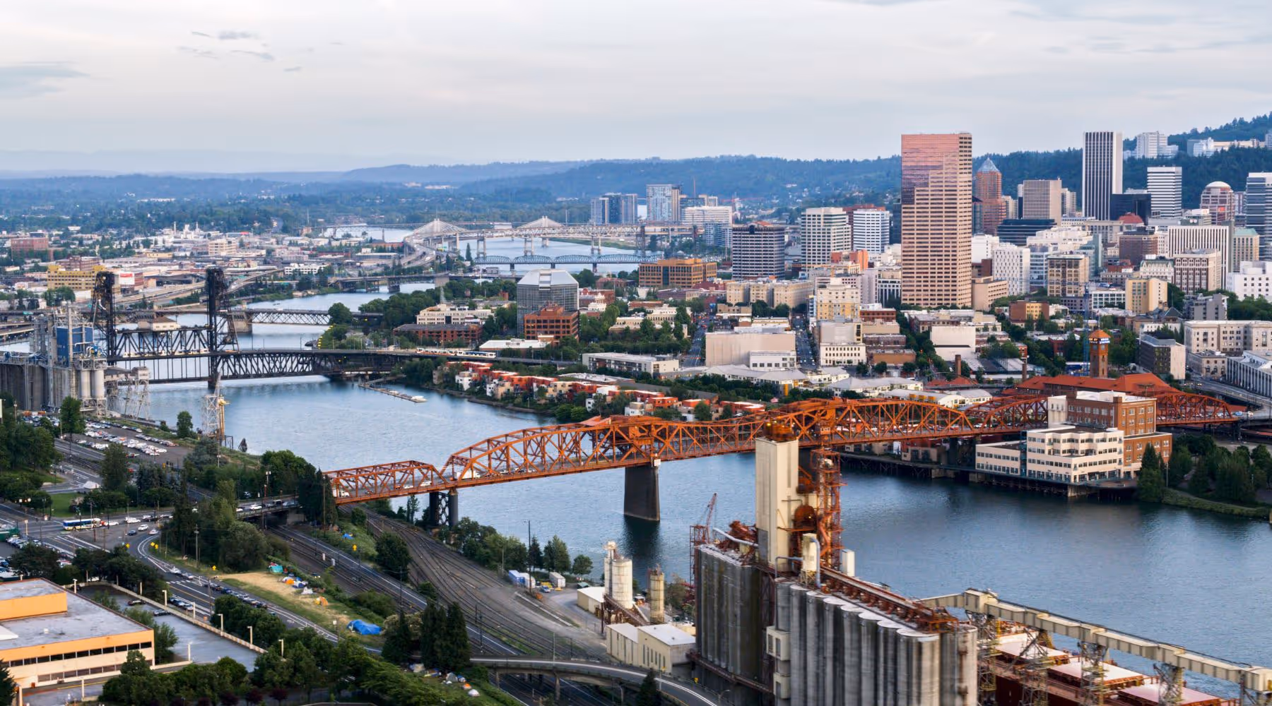 Portland city skyline with multiple bridges spanning over a river and urban buildings.