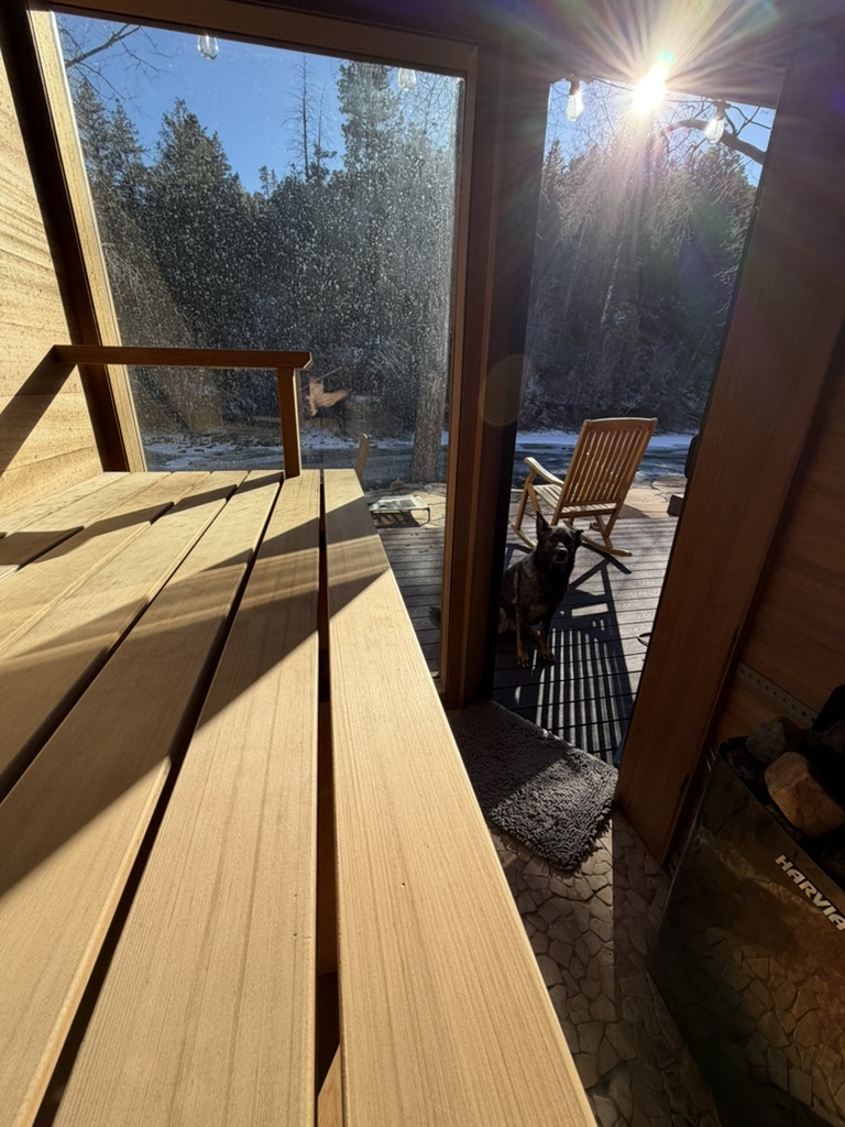 Sauna deck with sunlight streaming through glass