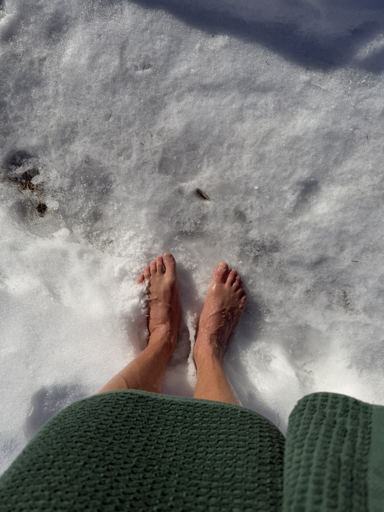 Bare feet on frozen ice after cold plunge