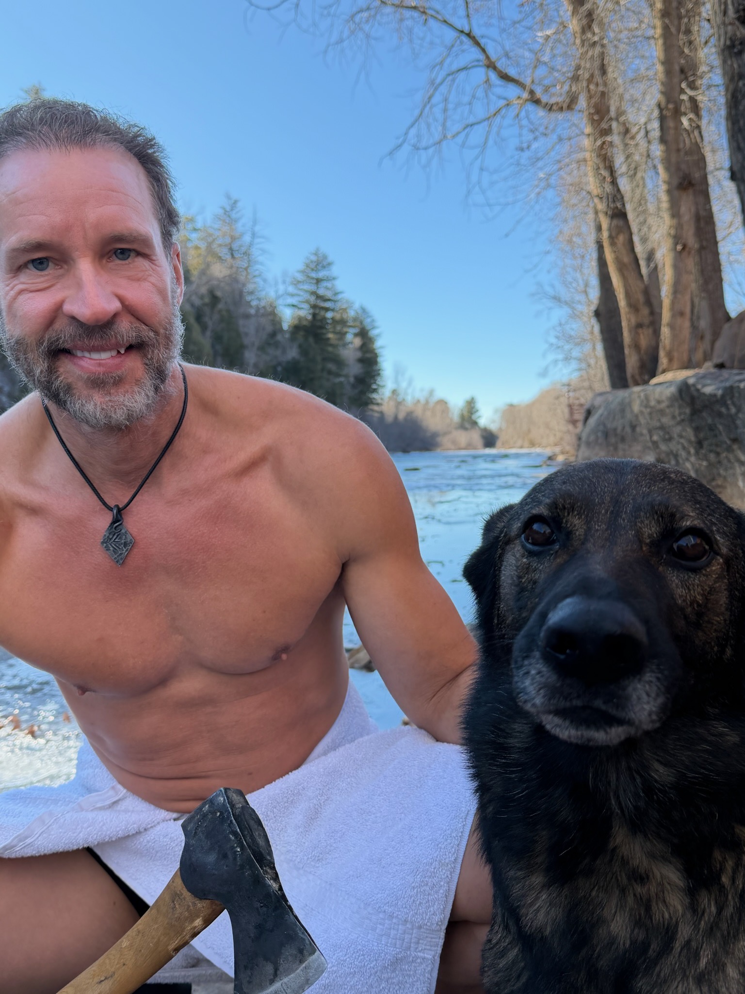 Erik with his dog by the river
