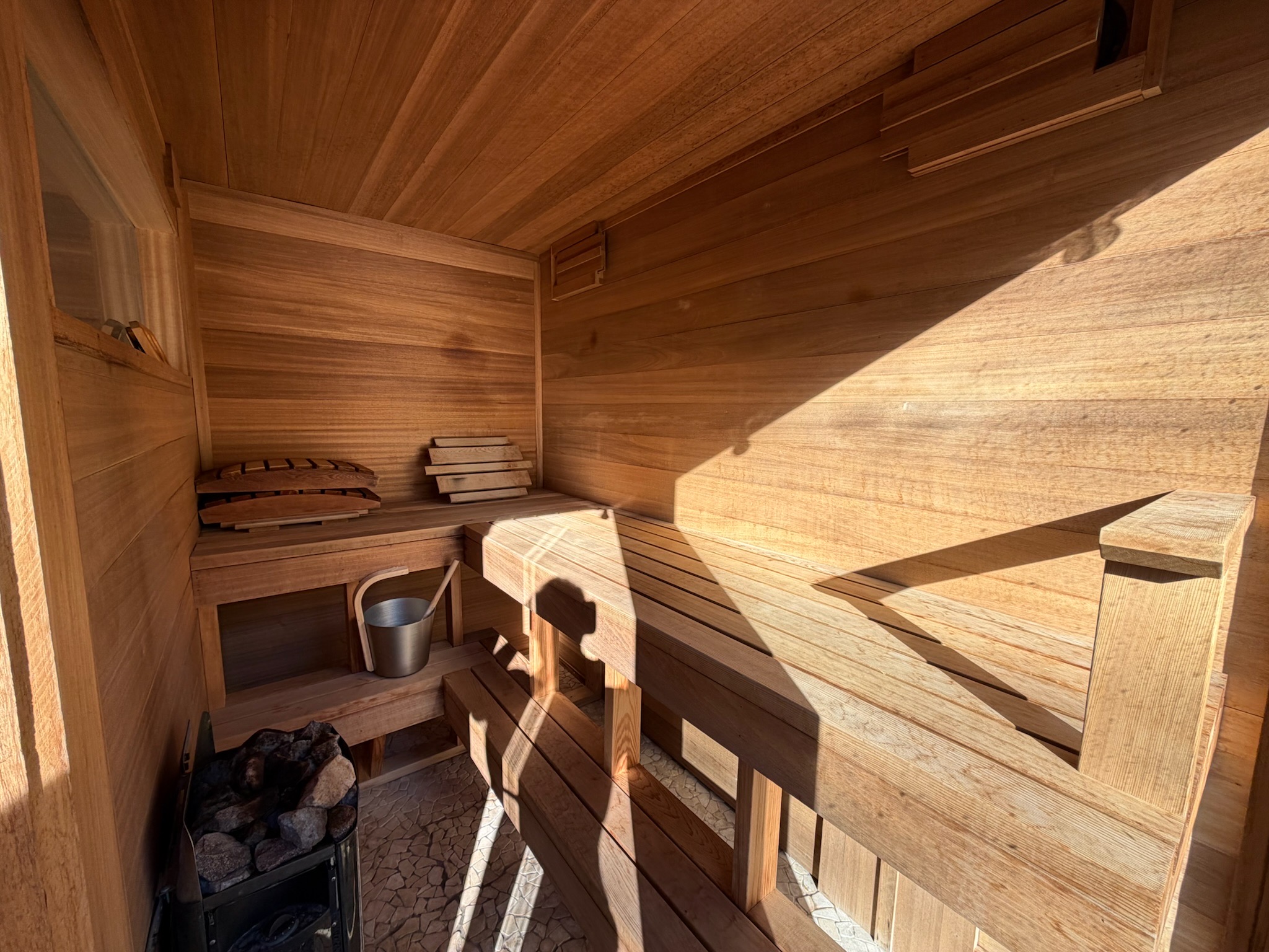 Beautiful cedar sauna interior bathed in sunlight