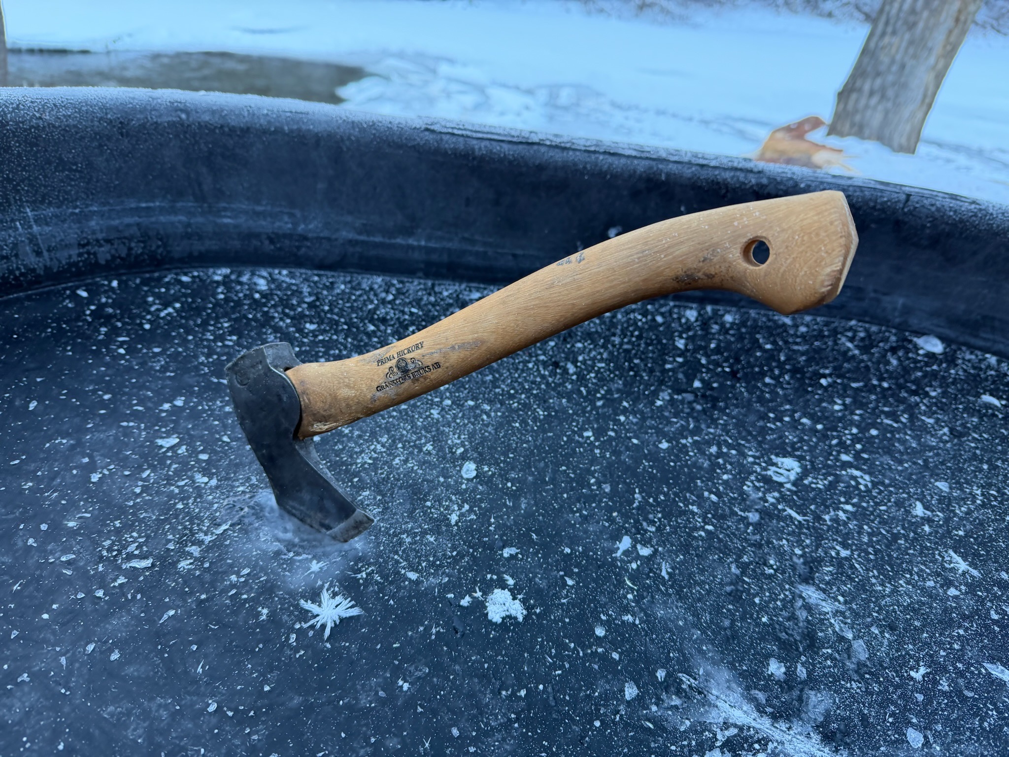 Viking axe embedded in frozen ice plunge tub