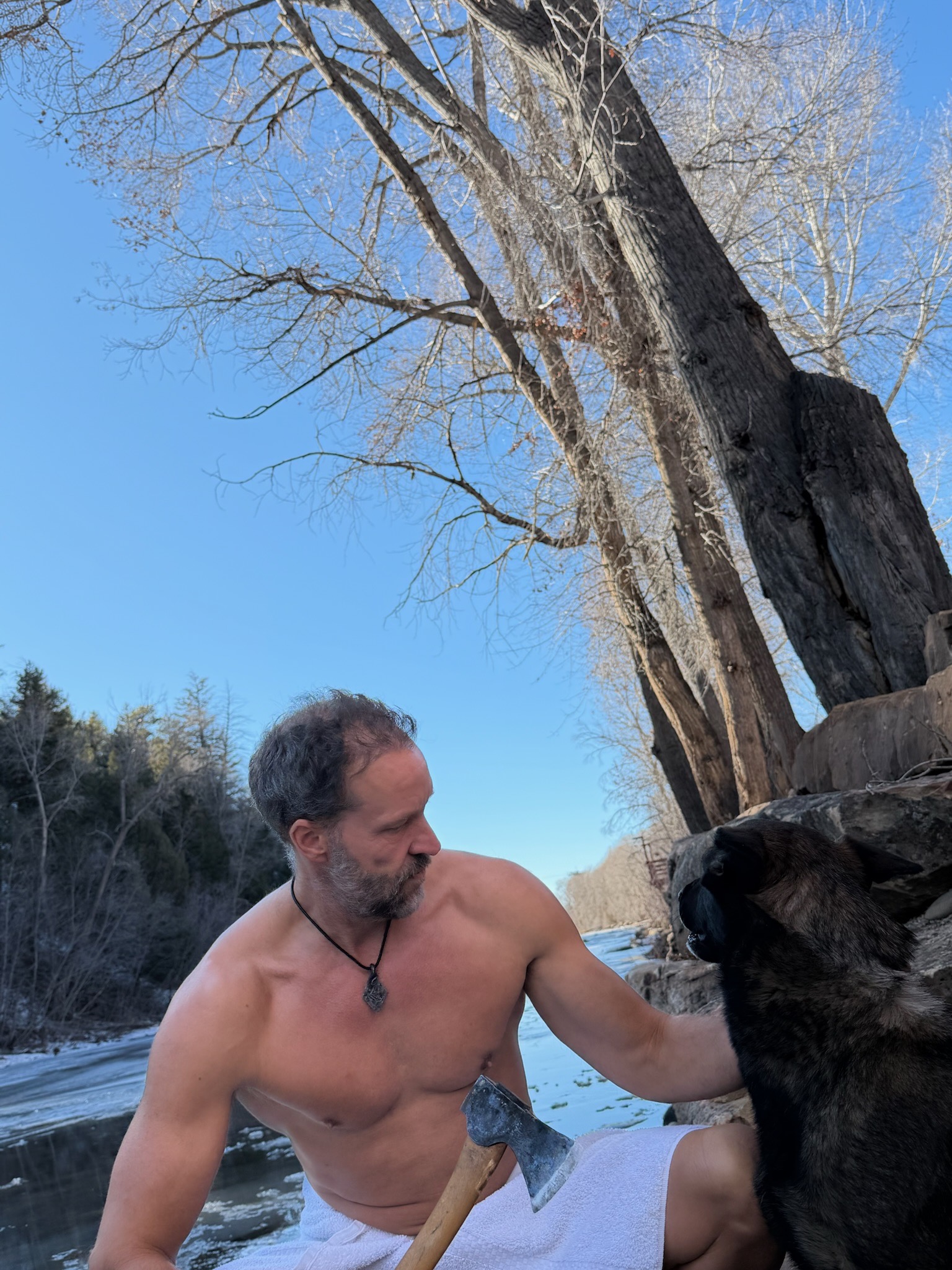 Erik with axe and dog in the winter wilderness