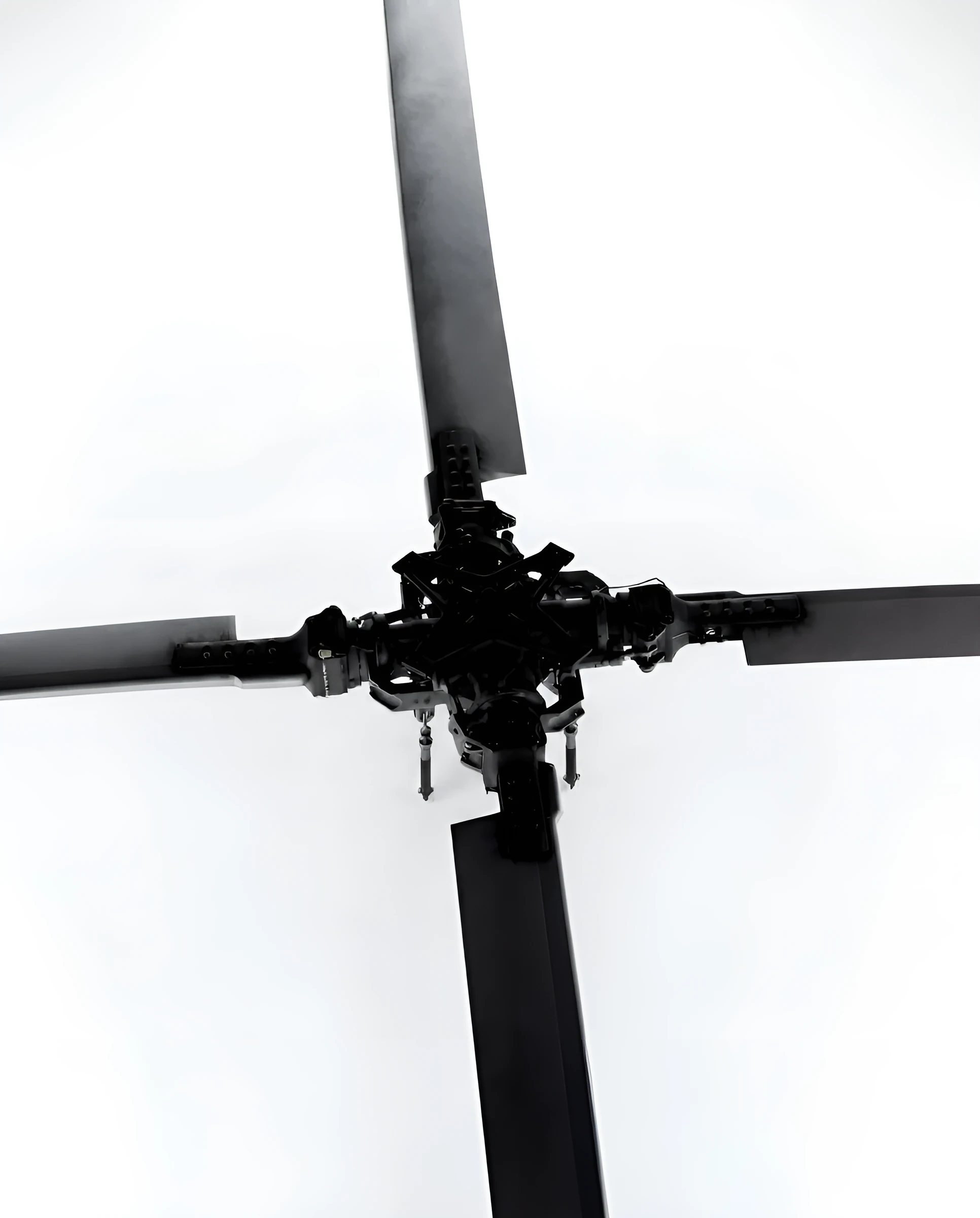 Helicopter rotor head photographed against a white background
