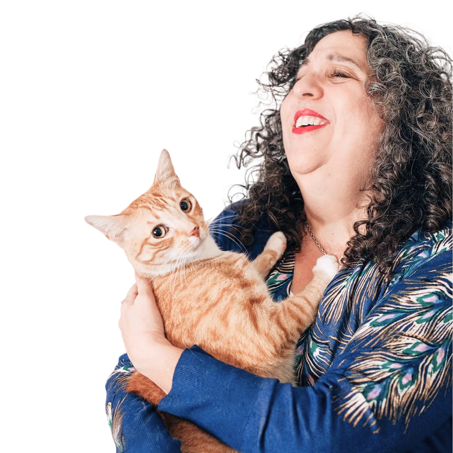 Kara smiling while holding an orange tabby cat.