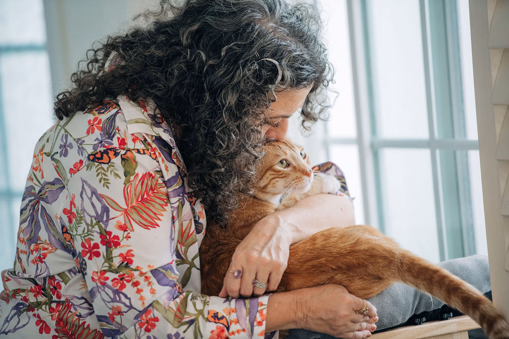 Kara hugging tabby cat
