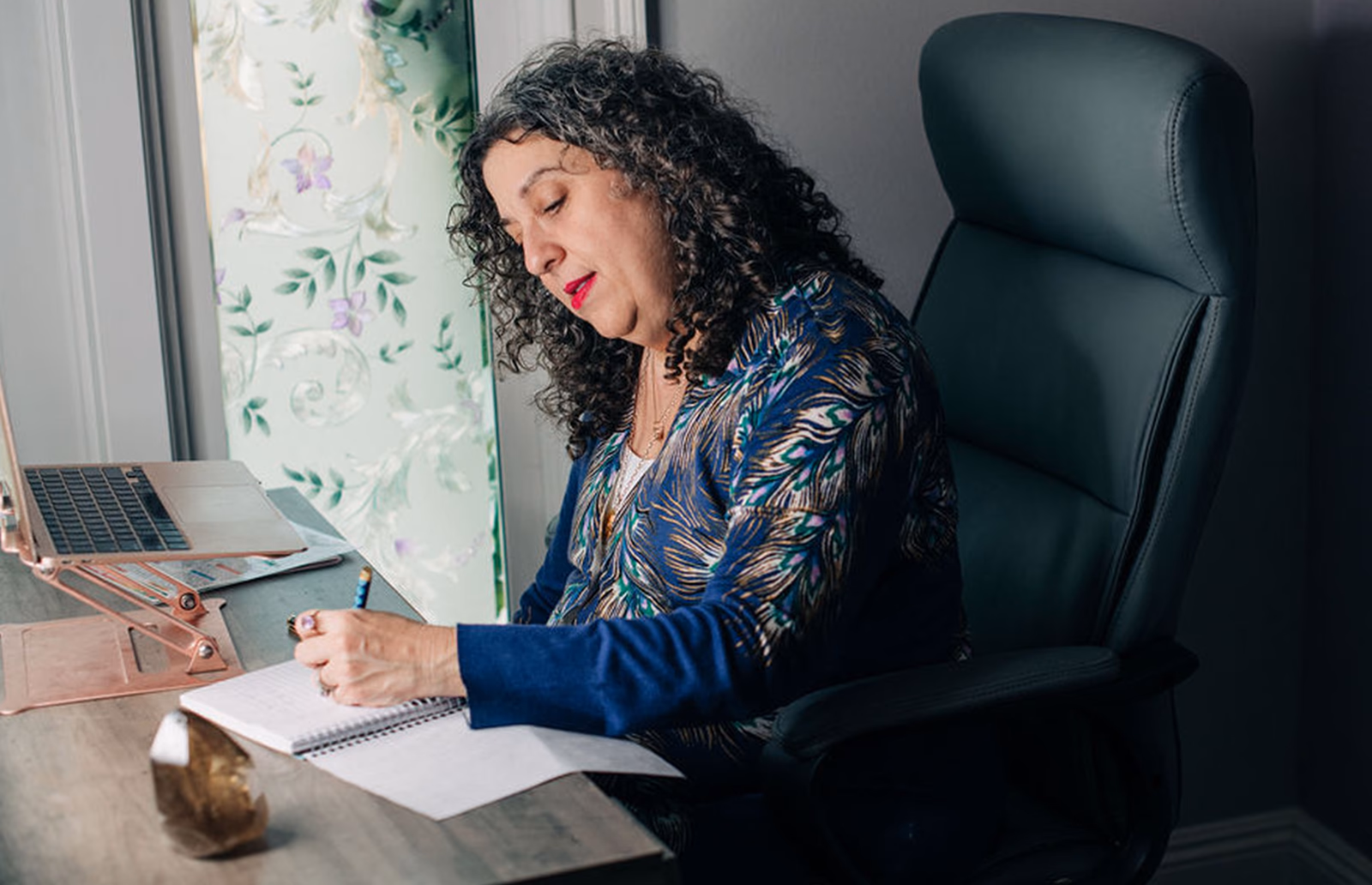 Kara writing at her desk.