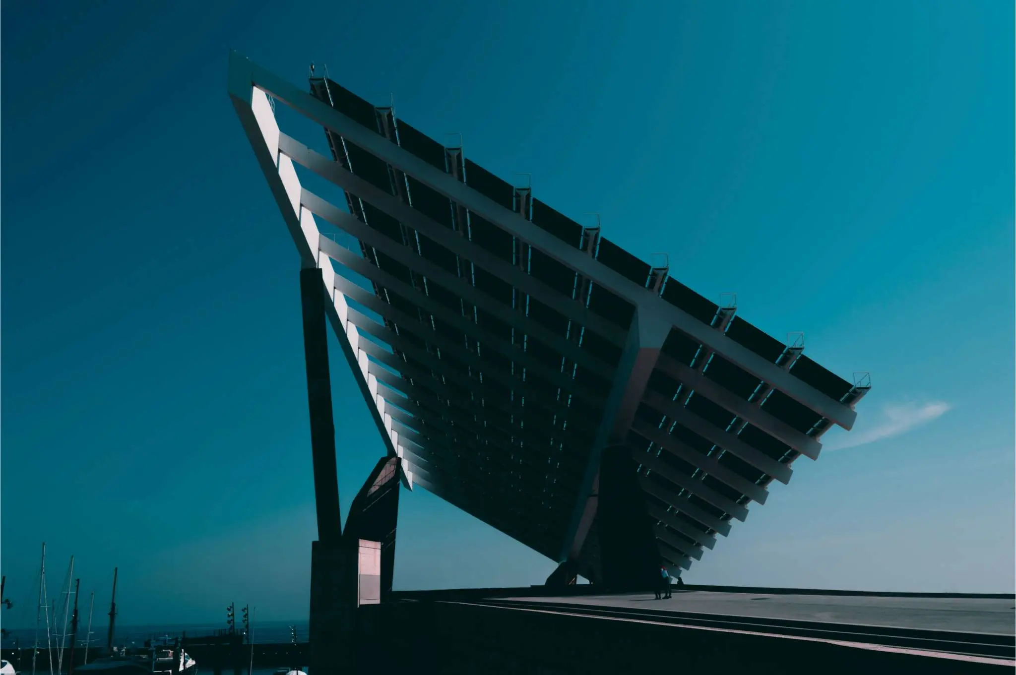 Large angled solar panel installation with a clear blue sky in the background.