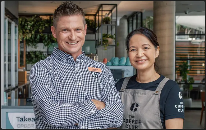 Coffee Club owners smiling together in their venue