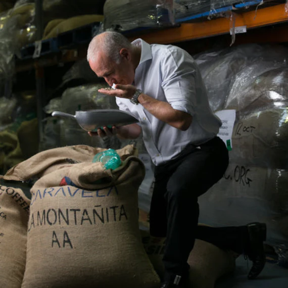 Gino Merlo checking green coffee beans at the Merlo roastery