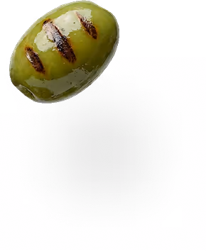 Single green olive with three dark grill marks on a white background casting a shadow.