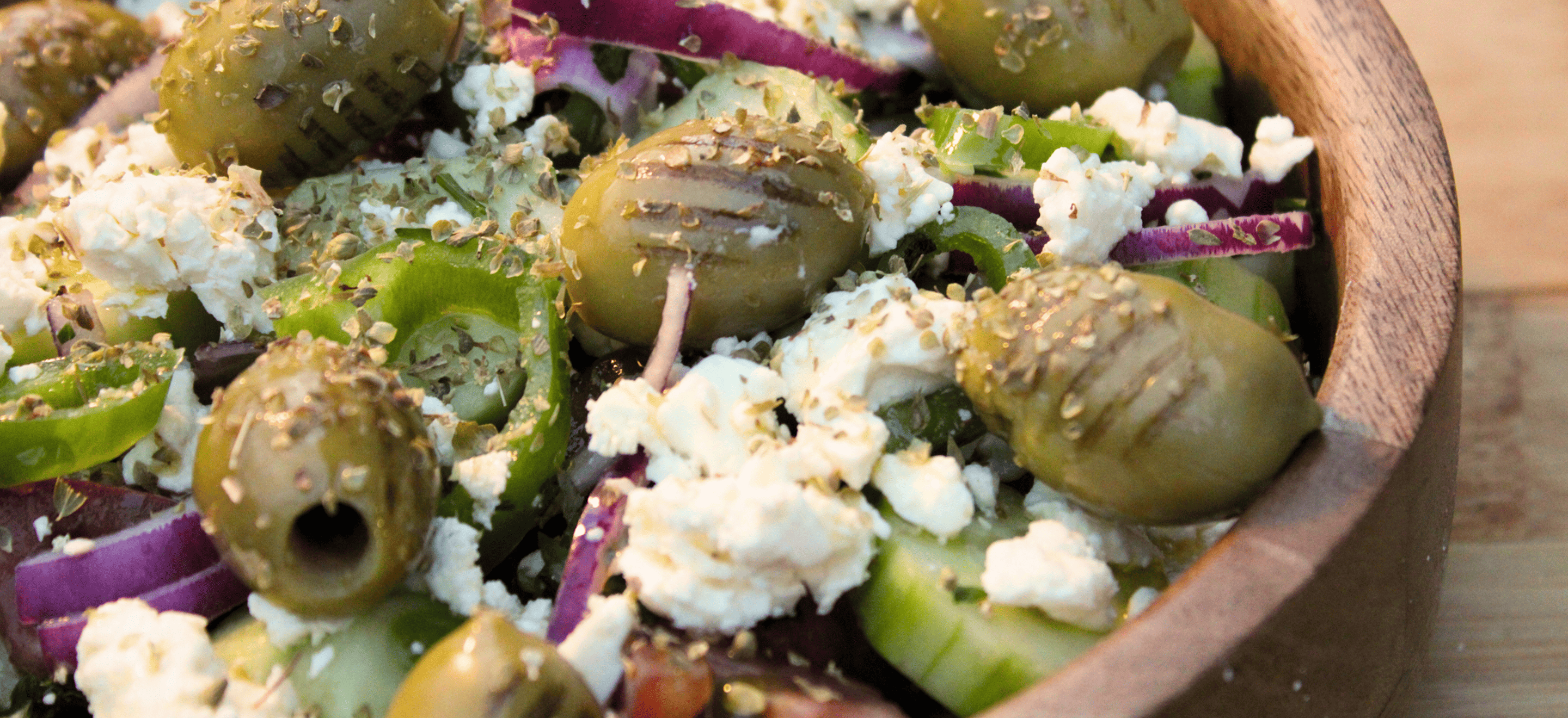 “Colorful Loveats Mediterranean salad with feta, olives, tomatoes, cucumbers, and fresh herbs.”