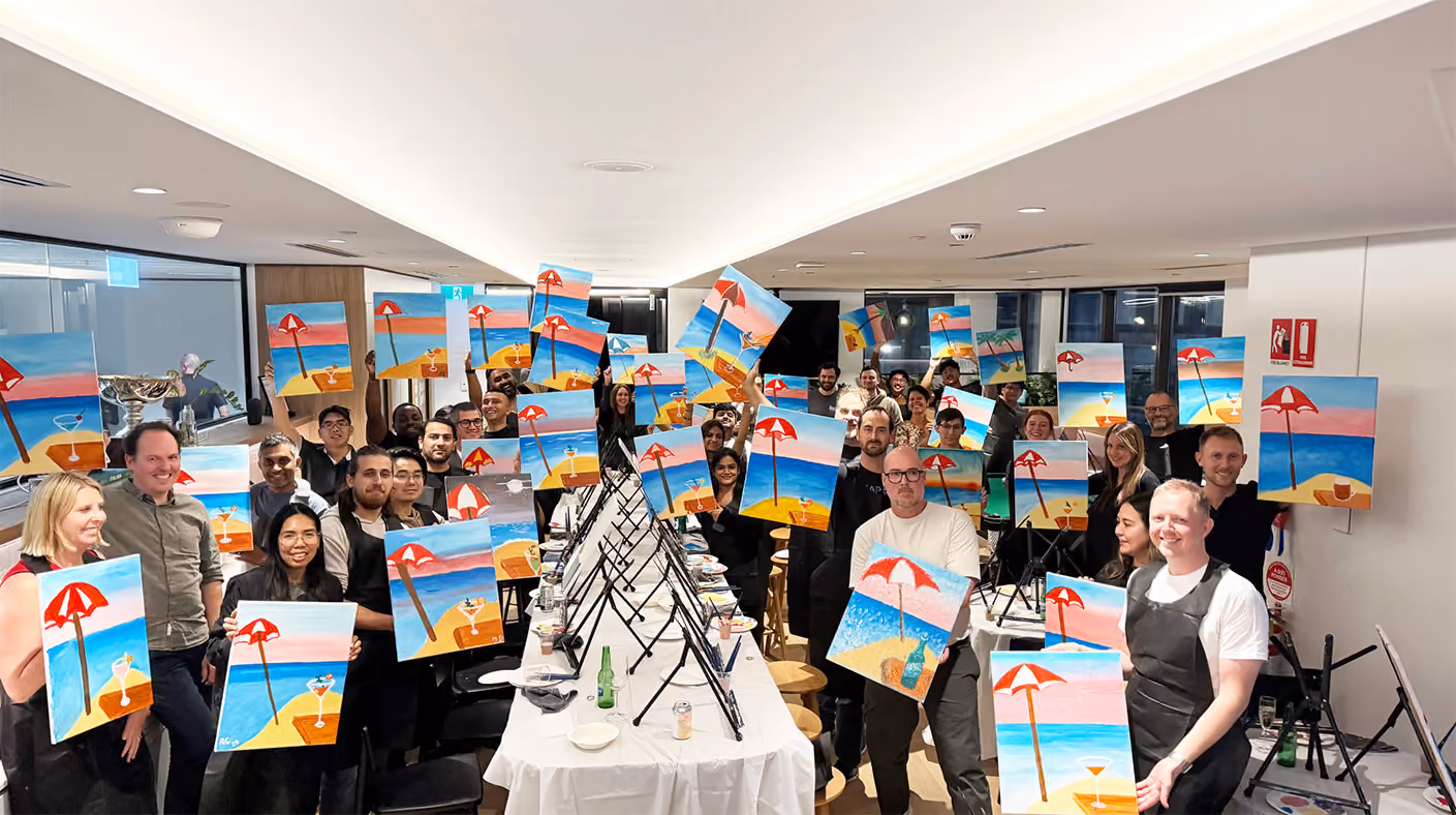 CORTO team holding their painted canvases at a group painting event in Sydney.