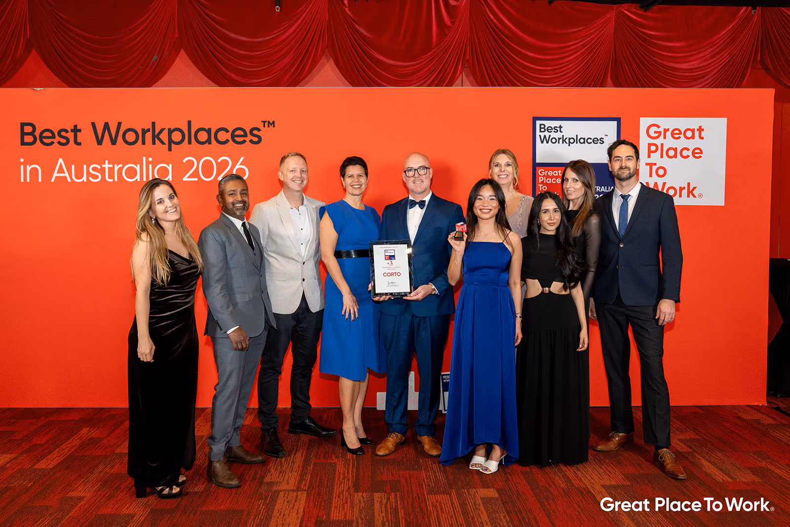 The CORTO team at the Best Place to Work Awards dinner, holding their award for 3rd place in Australia.
