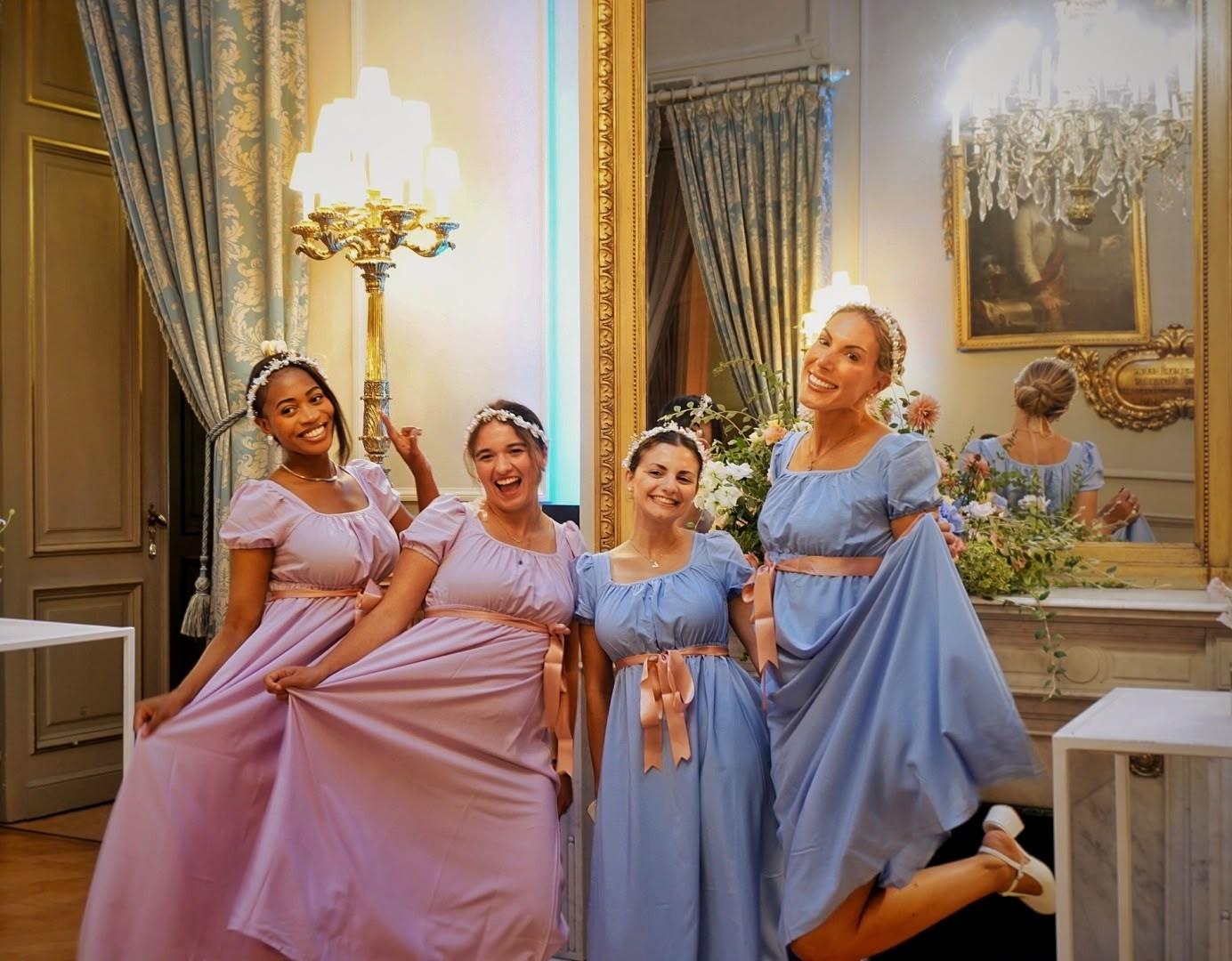 Hostesses in Regency gowns for a Bridgerton-themed evening at Concert Noble