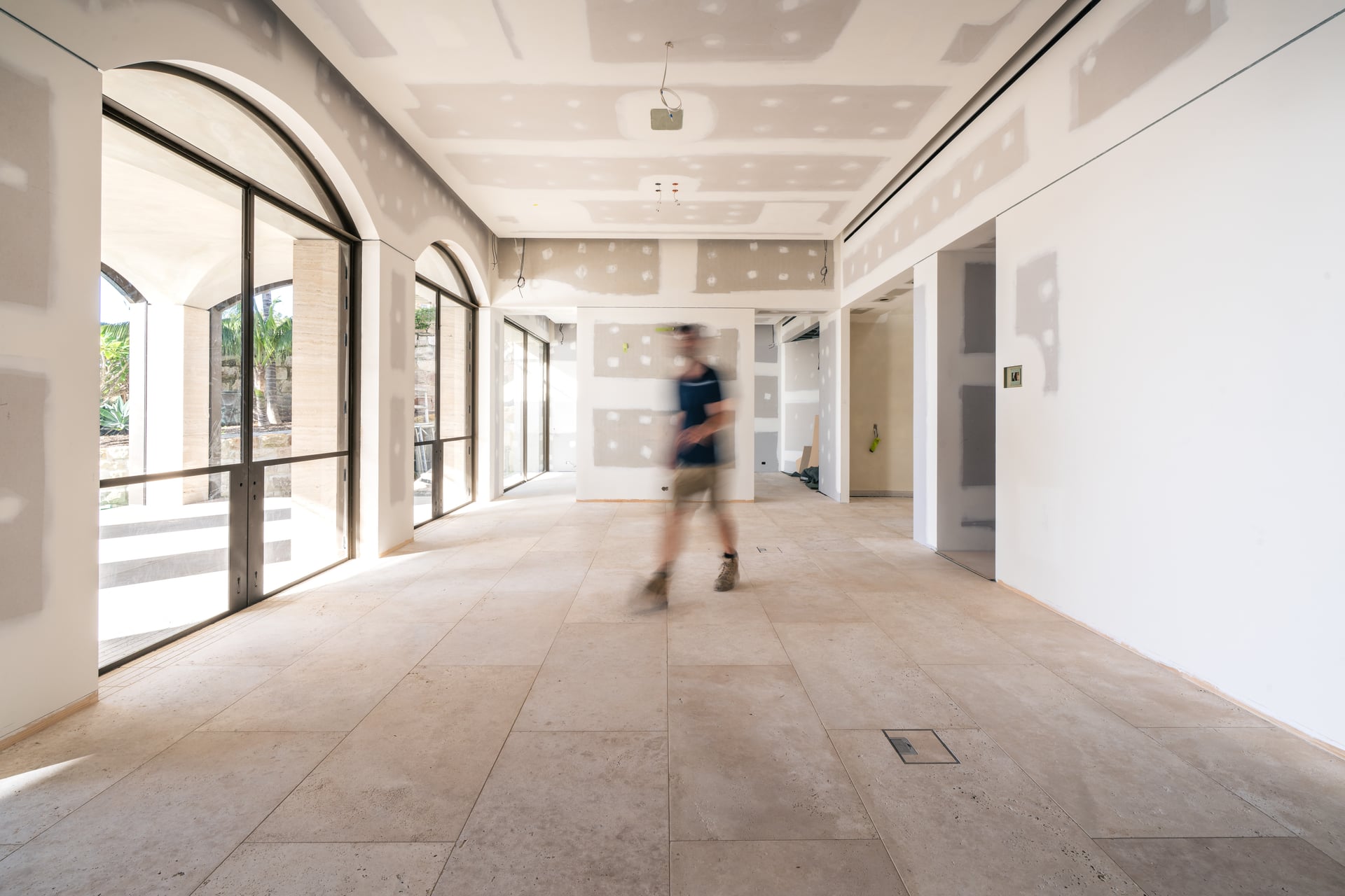 A Sydneyside Contracting team member on site inside a residential build at plastering stage