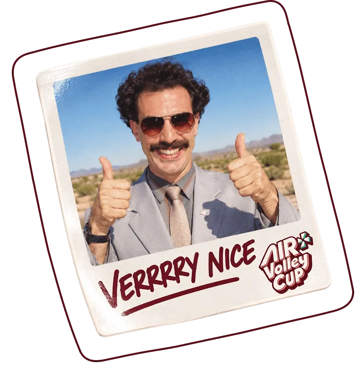 Man with curly dark hair, mustache, and sunglasses wearing a gray suit and tie, smiling and giving two thumbs up outdoors with a desert landscape in the background, framed like a Polaroid photo with text 'VERRRRY NICE' and 'Air Volley Cup' logo below.