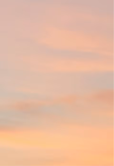 The UT Austin Tower silhouetted against a pink and orange sunset sky