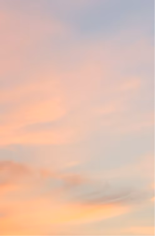 Softly colored sky at sunset with light pink, orange, and blue hues and wispy clouds.