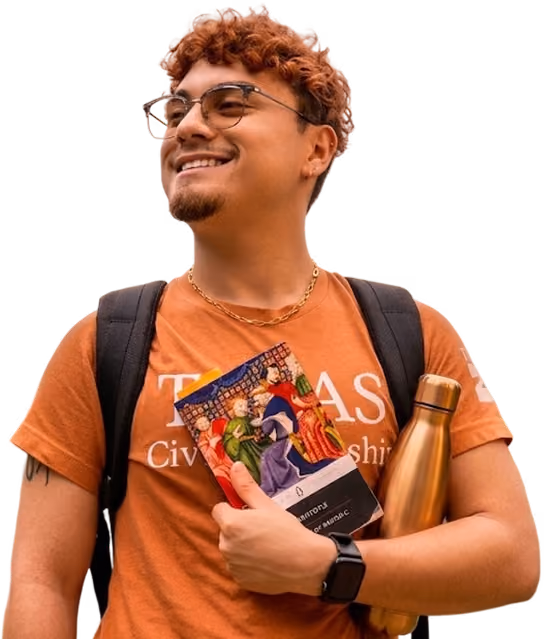 Smiling young man with glasses, orange shirt, backpack, holding a book and gold water bottle.