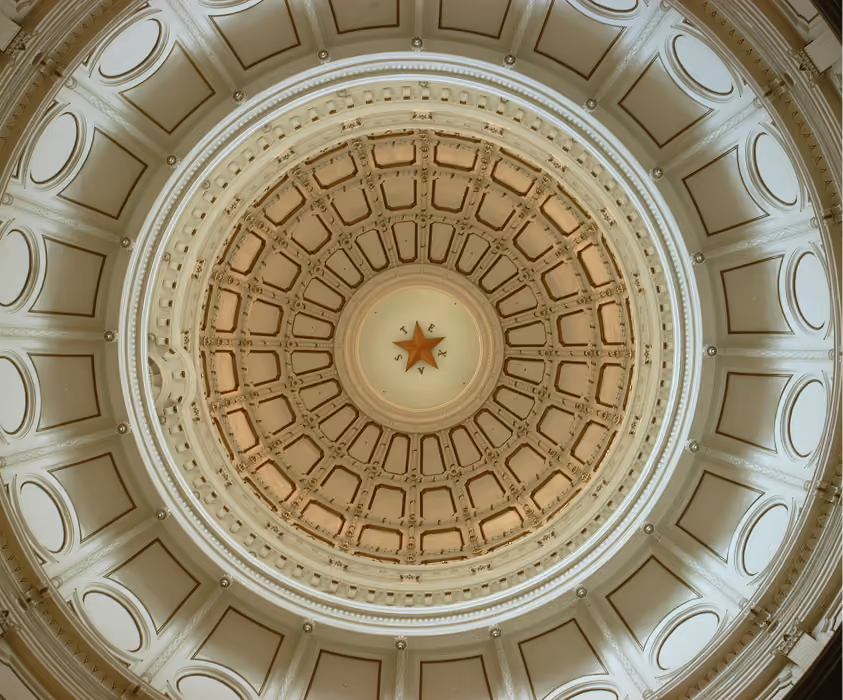 Intricately designed dome ceiling with a central star and the word TEXAS around it.