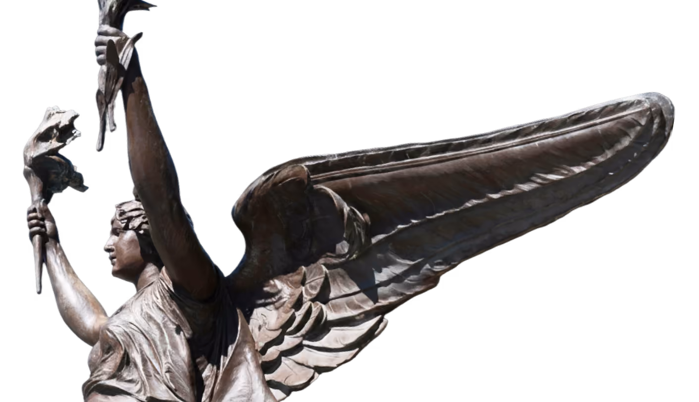 Bronze statue of an angel with detailed wings holding a torch in each hand.
