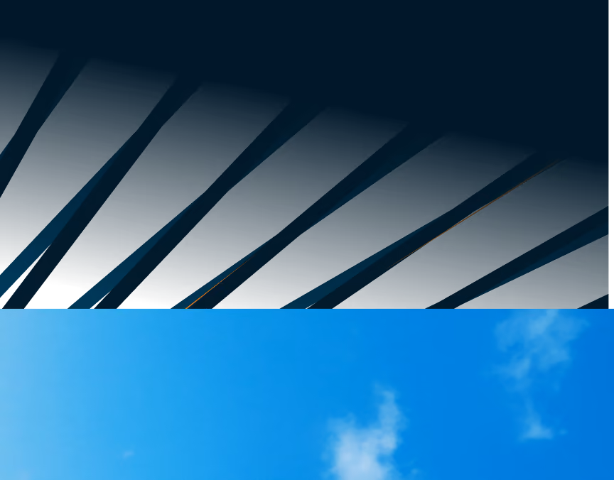 Dark sharply pointed silhouettes against a bright blue sky with few white clouds.