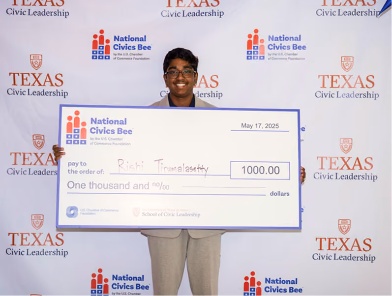 Smiling person holding a large $1,000 National Civics Bee check dated May 17, 2025 with Texas Civic Leadership backdrop.