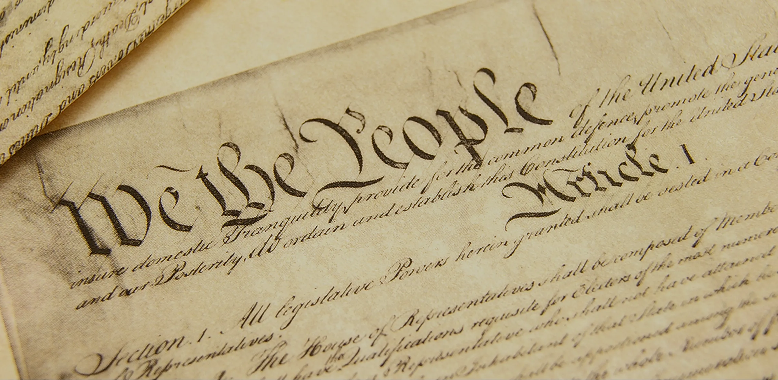 'We the People' calligraphy from the United States Constitution document.