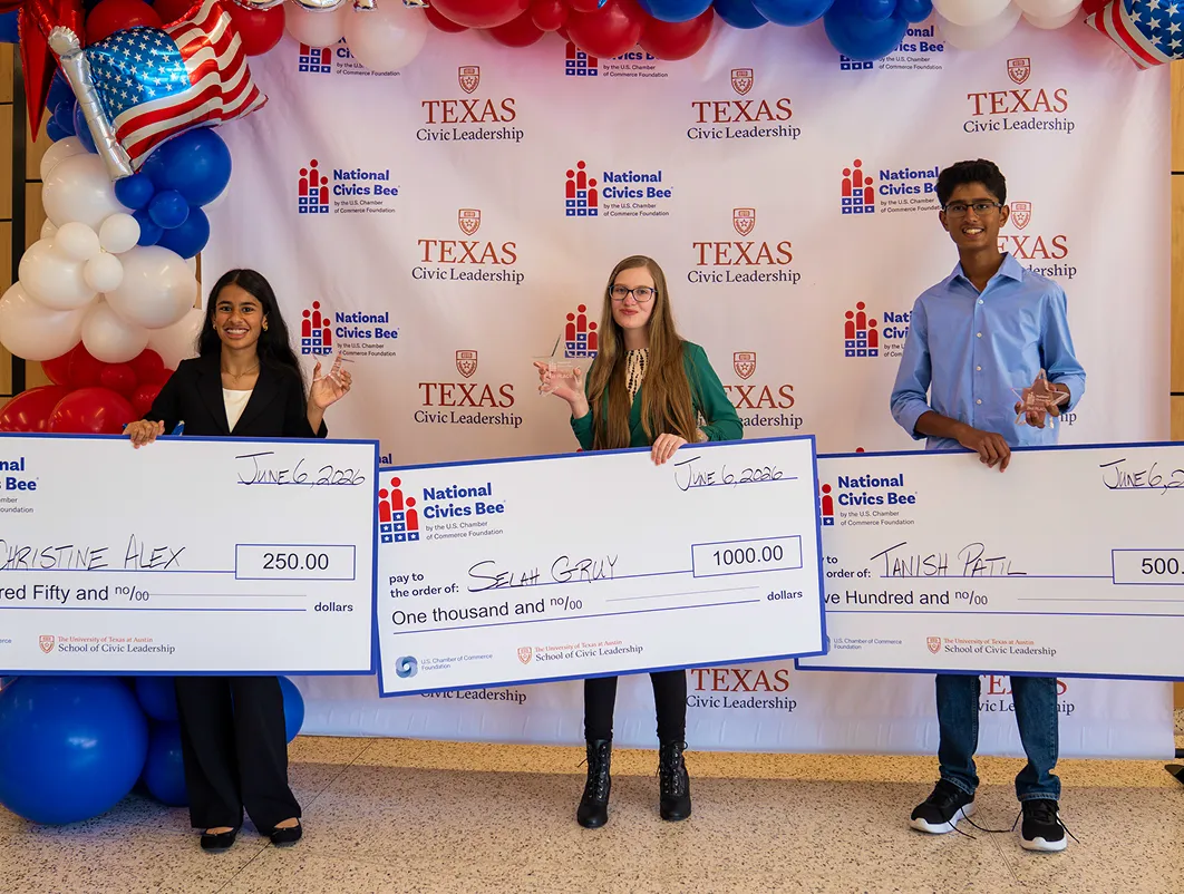 Three winners holding oversized checks and trophies at Texas Civic Leadership National Civics Bee event.