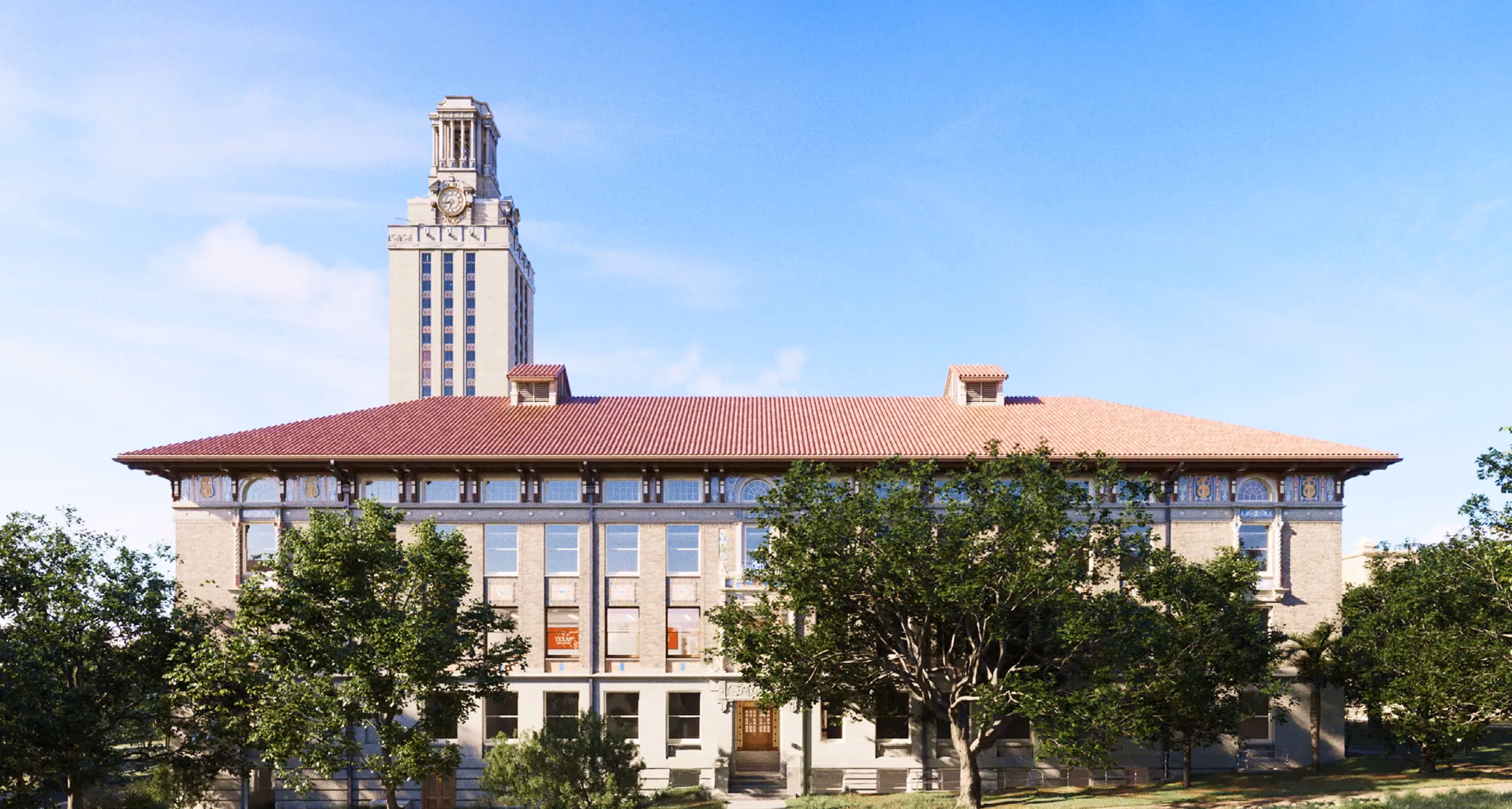 Historic beige building with red tile roof and trees in front under blue sky.