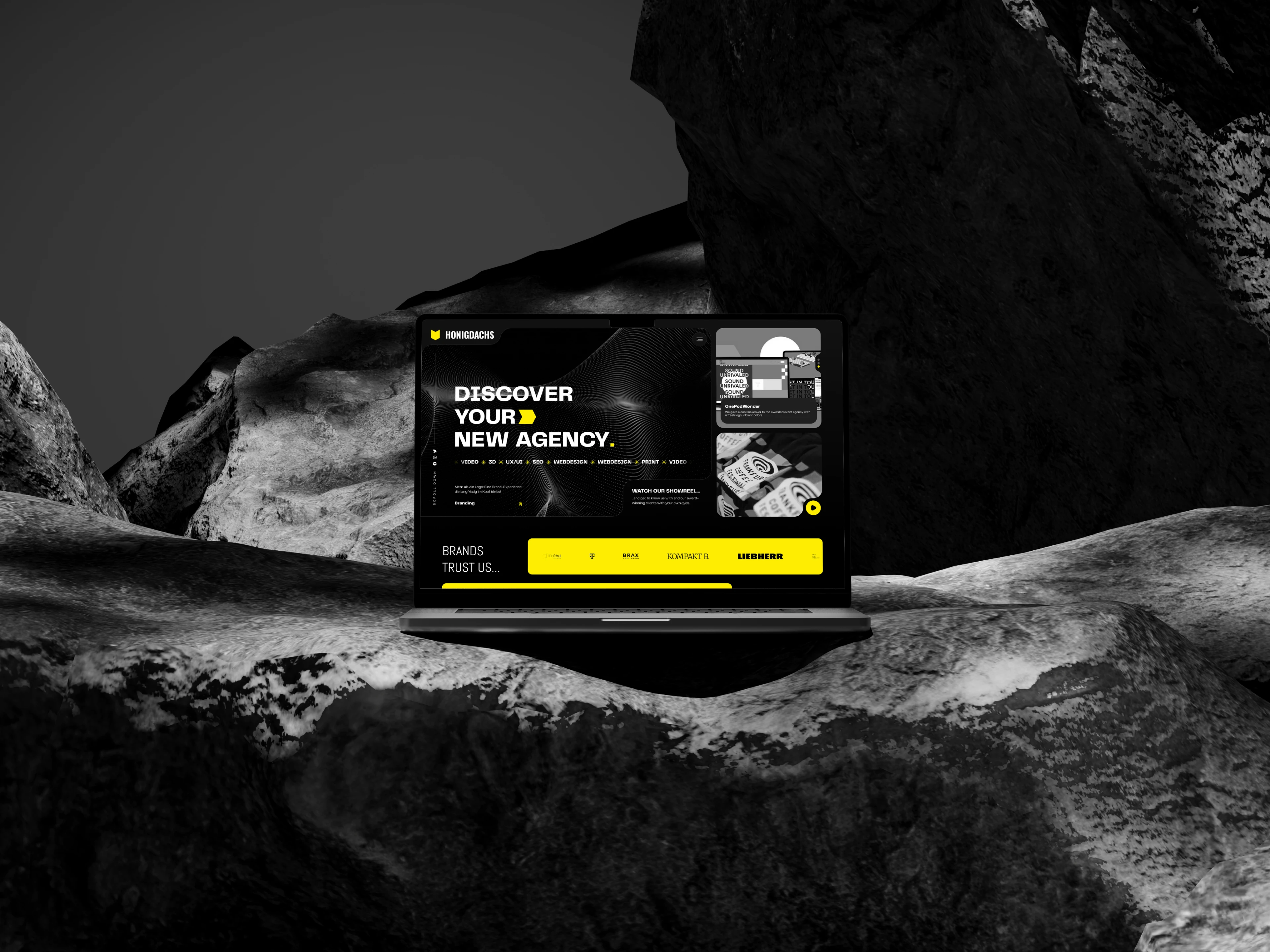 A laptop positioned on a rock, highlighted by a bold yellow and black backdrop, emphasizing its modern design