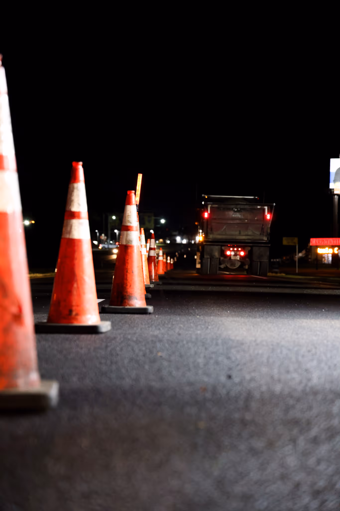 CWR Contracting night paving operation with safety cones and work lights