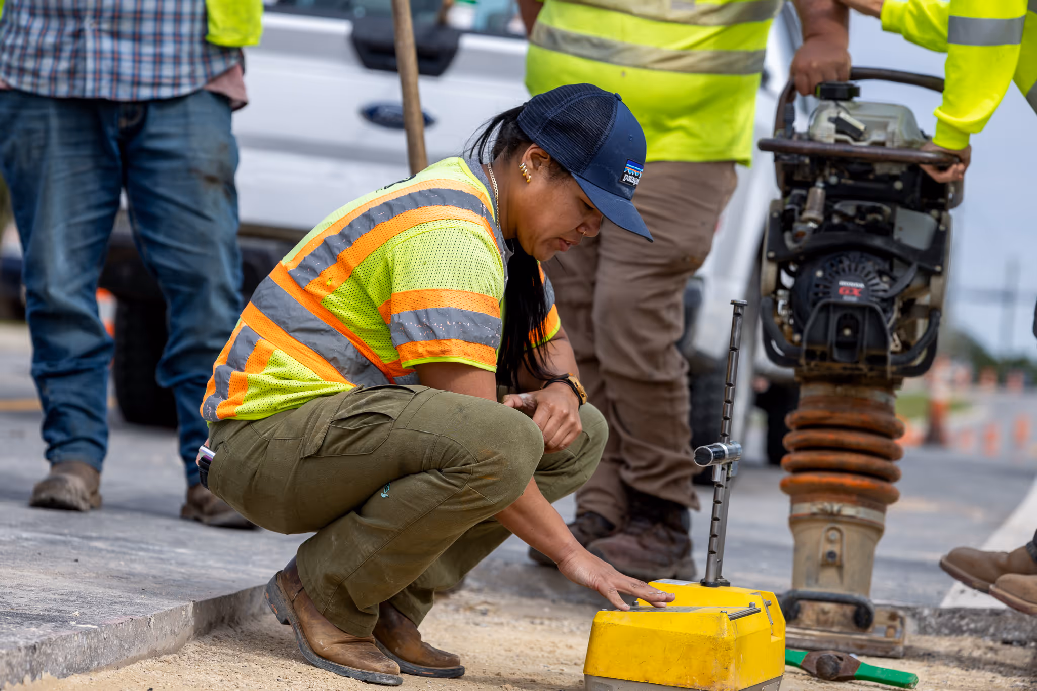 CWR Contracting worker in safety gear operating a paver