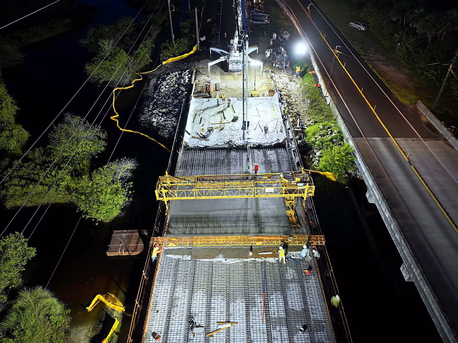 CWR Contracting crews placing a bridge deck at night under floodlights in Florida