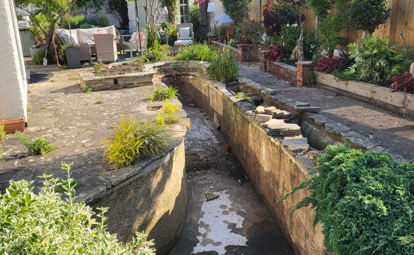 Patchy bare garden lawn before turfing in Worthing, West Sussex