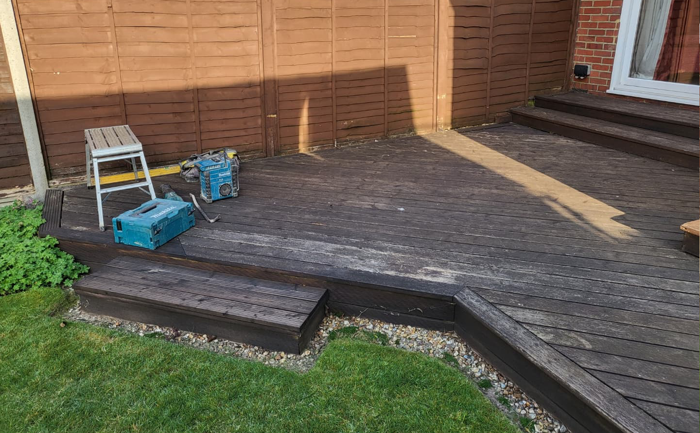 Old worn garden area before new decking installation in Worthing, West Sussex