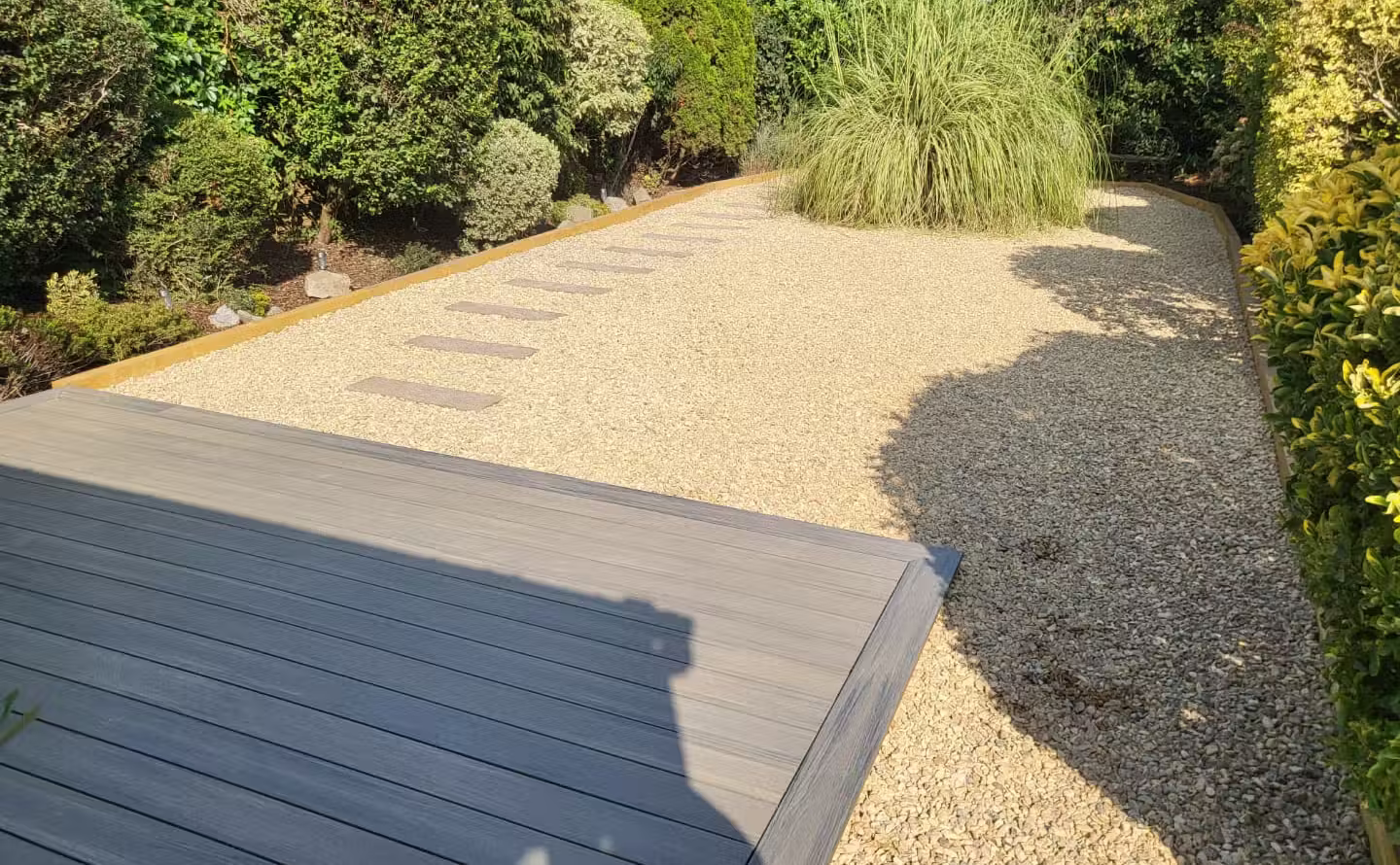 Decorative gravel garden with paved slab pathway after landscaping in Worthing, West Sussex