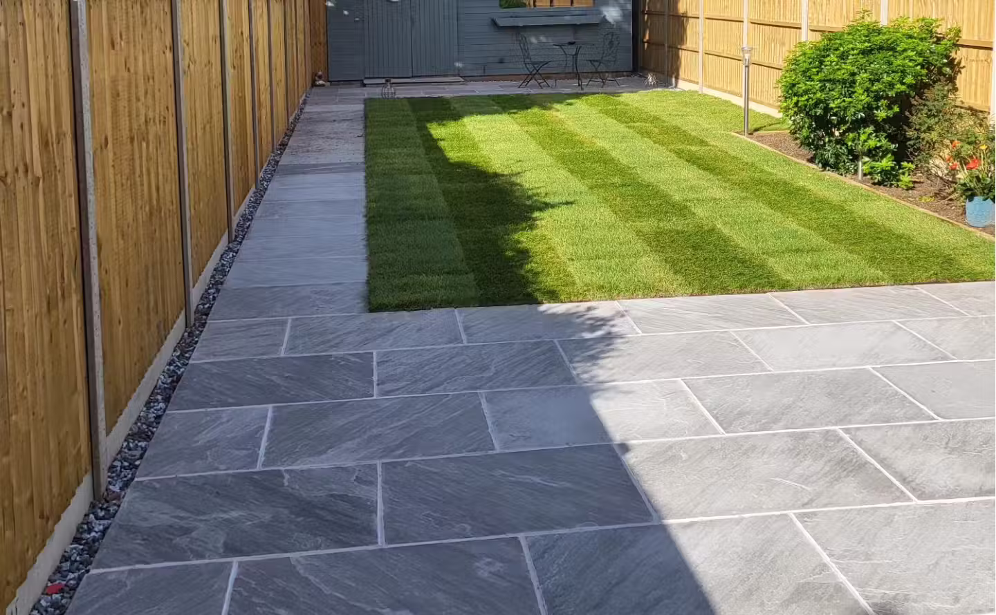New patio with freshly laid turf lawn after landscaping in Worthing, West Sussex